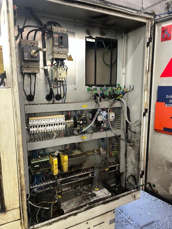 Painel elétrico do comando CNC antes da manutenção, com fuligem e sujeira acumulada